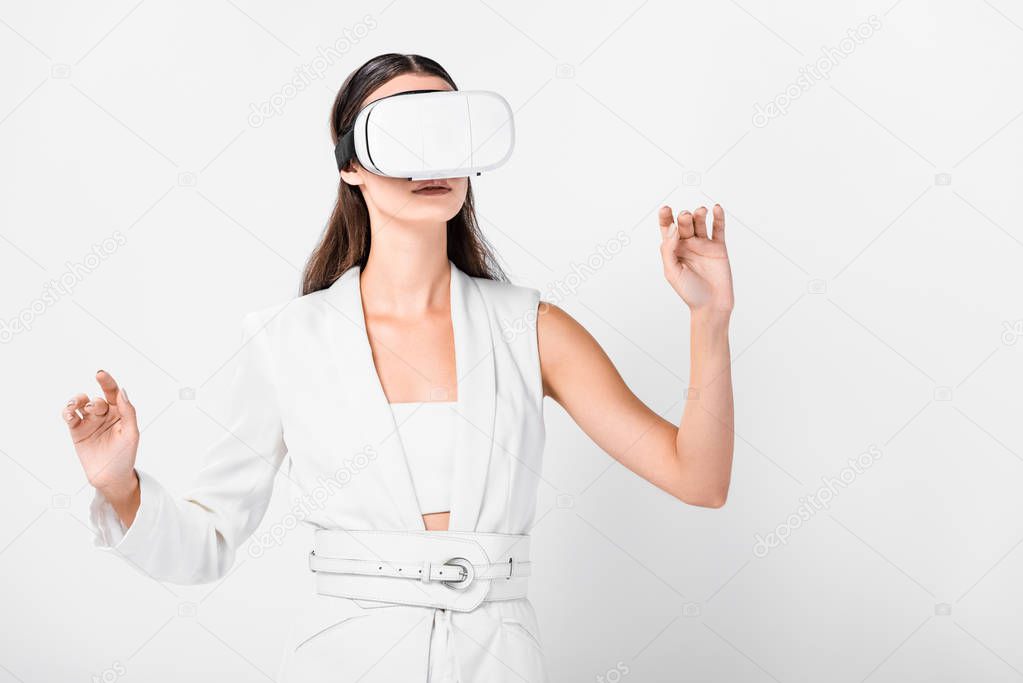 close up of adult woman gesturing in virtual reality headset isolated on white