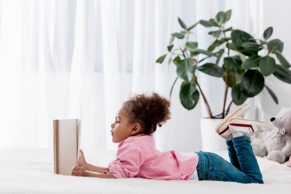 Adorable Niño Afroamericano Acostado Cama Leyendo Libro — Foto de Stock