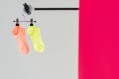 pair of multicolored socks on hanger with copy space clipart