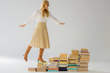 adult elegant woman balancing on vintage books  clipart