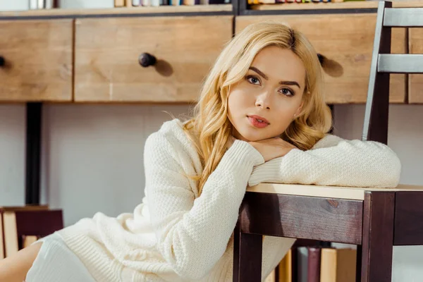 close up of attractive blonde woman with chair