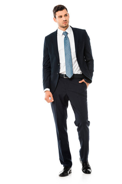 serious handsome businessman in suit standing isolated on white
