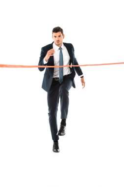 handsome businessman in suit running to finishing line isolated on white clipart