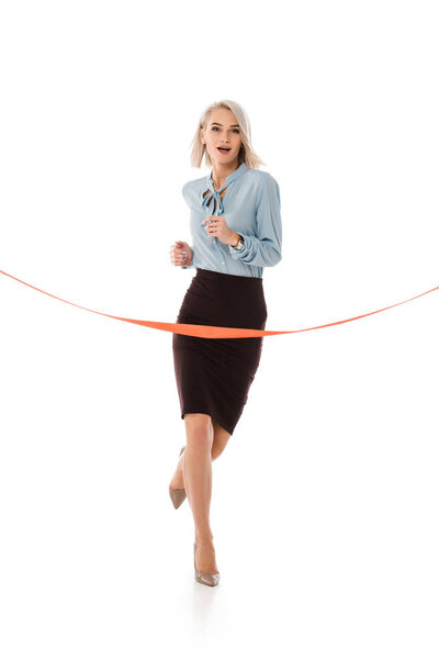 attractive businesswoman running to red finishing line isolated on white