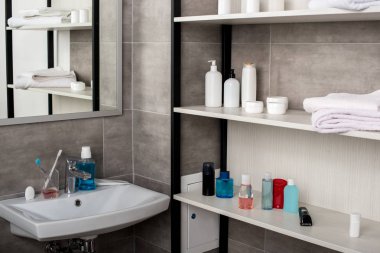 seçici odak ile modern banyo, lavabo ve güzellik ürünleri ile raflar