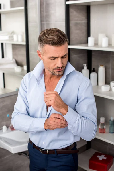 Confident Adult Businessman Buttoning Blue Shirt Bathroom Home — Stock Photo, Image