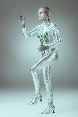 full length view of silver woman robot walking on grey, future technology concept   clipart