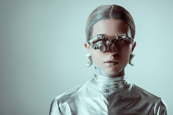 futuristic silver robot looking at camera isolated on grey, future technology concept  