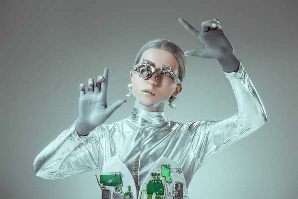futuristic silver robot gesturing with hands isolated on grey, future technology concept