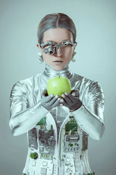 Cyborg Holding Green Apple Looking Camera Isolated Grey Future Technology — Free Stock Photo