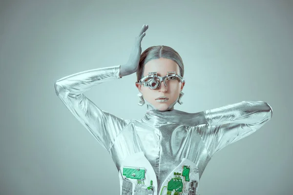 young woman robot looking at camera isolated on grey, future technology concept