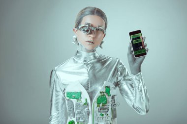 robot Smartphone rezervasyon uygulaması ile tutarak ve izole gri, geleceğin teknoloji kavramı üzerinde kamera bakıyor   