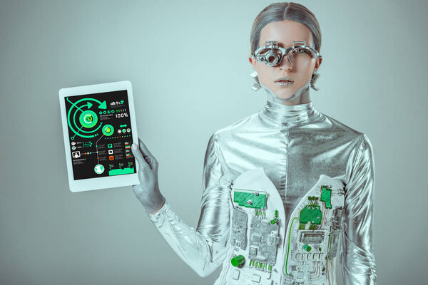 silver robot holding tablet with infographics isolated on grey, future technology concept