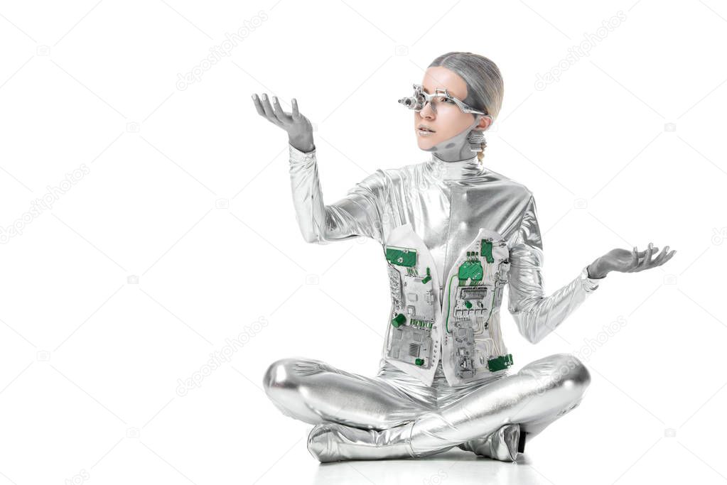 silver robot sitting and touching something isolated on white, future technology concept