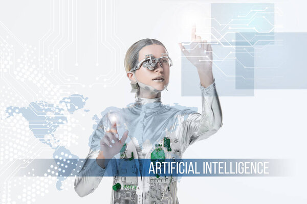 silver cyborg with eye prosthesis touching digital data isolated on white, future technology concept with "artificial intelligence" lettering