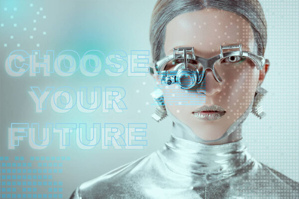 close-up view of silver robot with eye prosthesis looking at camera on grey with "choose your future" lettering and digital data