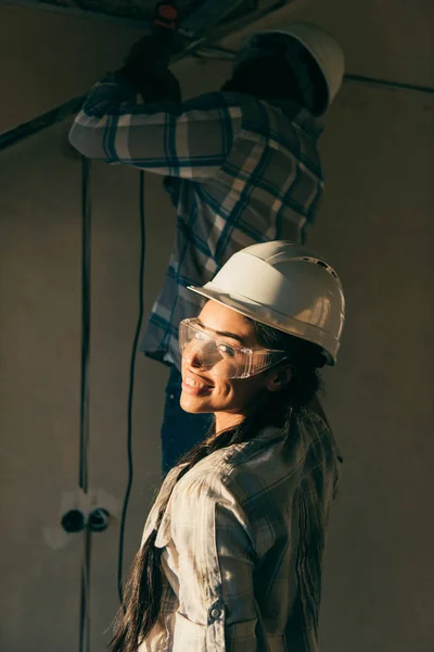 Happy Young Woman Hard Hat Looking Camera While Her Husband — Free Stock Photo