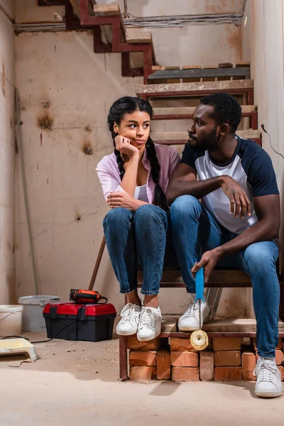 Tired Young African American Couple Sitting Stairs Renovation New Home — Free Stock Photo
