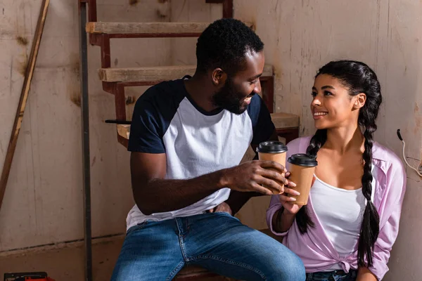 Young African American Couple Clinking Disposable Cups Coffee Renovation New — Free Stock Photo