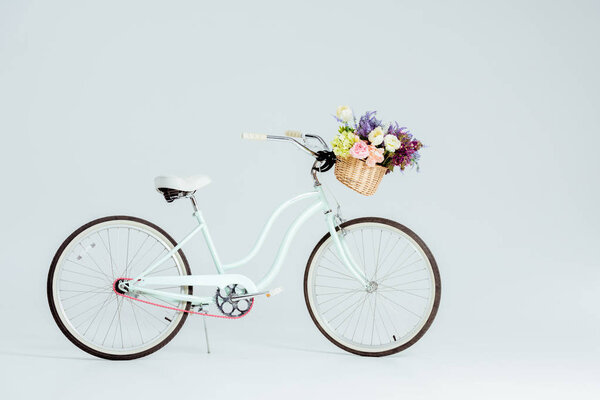 bicycle with flower basket isolated on grey