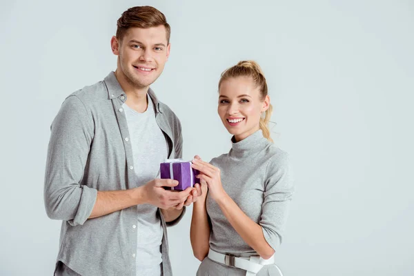 Couple Looking Camera Man Giving Present Woman Isolated Grey — Stock Photo, Image