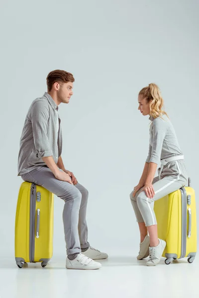 Couple Sitting Suitcases Looking Each Other Grey Background Travel Concept — Free Stock Photo