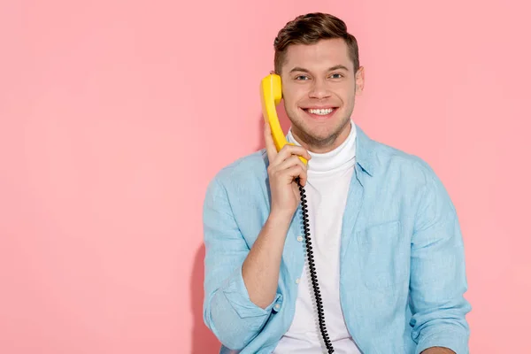 Homem Falando Telefone Vintage Amarelo Com Fundo Rosa — Fotografia de Stock