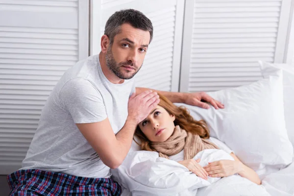 Handsome Husband Touching Forehead Sick Wife Fever Bed Looking Camera — Stock Photo, Image