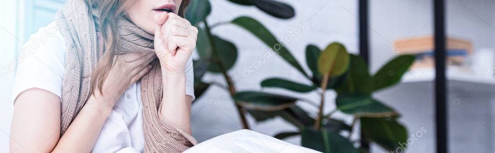 panoramic view of sick woman coughing at home