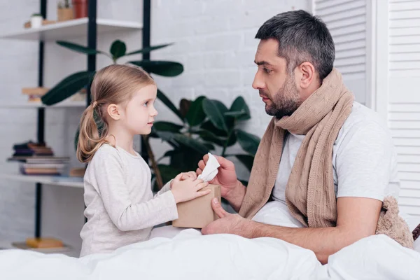 Side View Adorable Daughter Giving Napkins Sick Father Bedroom — Free Stock Photo