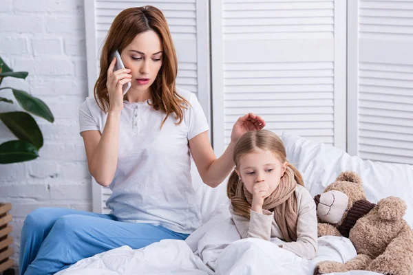 Mother Calling Doctor Smartphone Palming Sick Daughter Bed — Stock Photo, Image