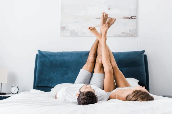 Young Boyfriend Girlfriend Lying Raised Legs Morning — Stock Photo, Image
