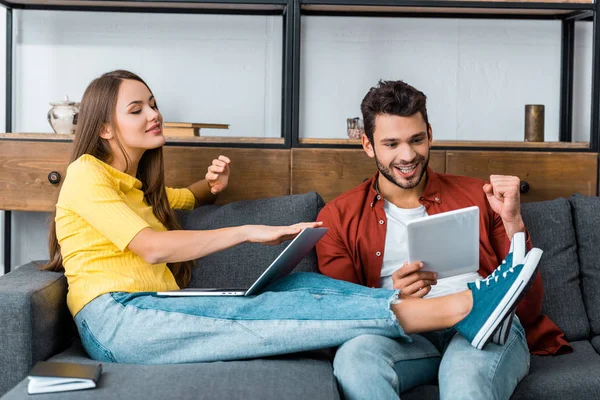 Young Cheerful Couple Spending Time Together Sofa Laptop Digital Tablet — Stock Photo, Image