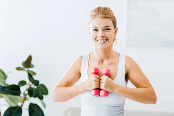 Sonriente Mujer Haciendo Ejercicio Con Mancuernas Mirando Cámara Casa — Foto de stock gratis