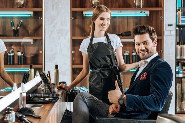 Smiling Young Hairdresser Looking Handsome Happy Client Showing Thumb Beauty — Stock Photo, Image