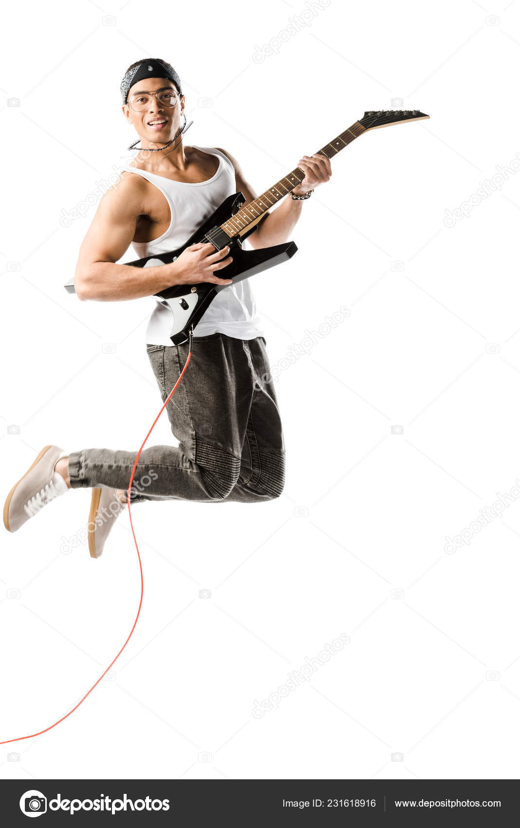 Happy Young Male Rocker Jumping Playing Electric Guitar Isolated White