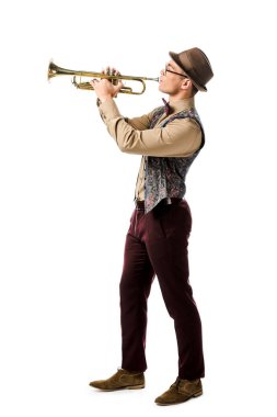 side view of hipster man in hat and eyeglasses playing on trumpet isolated on white  clipart