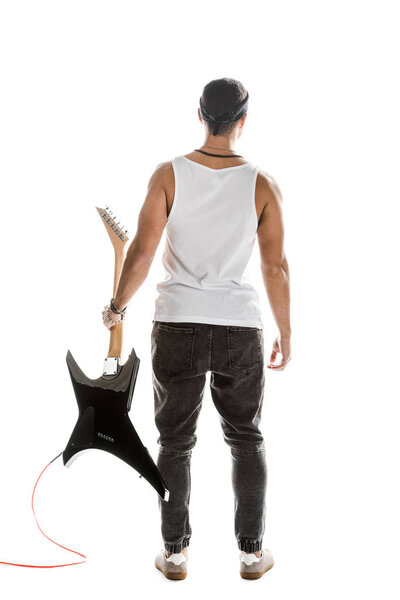 rear view of male rock musician posing with black electric guitar isolated on white