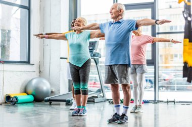 çok ırklı üst düzey sporcular spor salonunda egzersiz yaparak zaman uyumlu