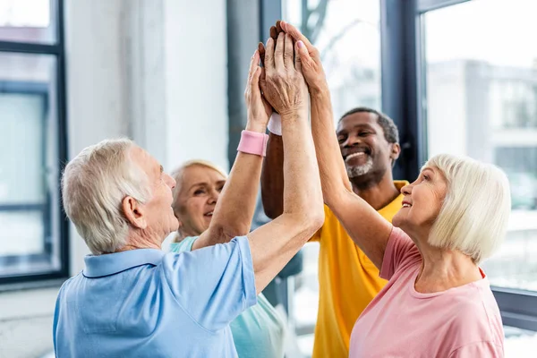 Selective Focus Happy Senior Multicultural Sportspeople Putting Hands Together Gym — Stock Photo, Image