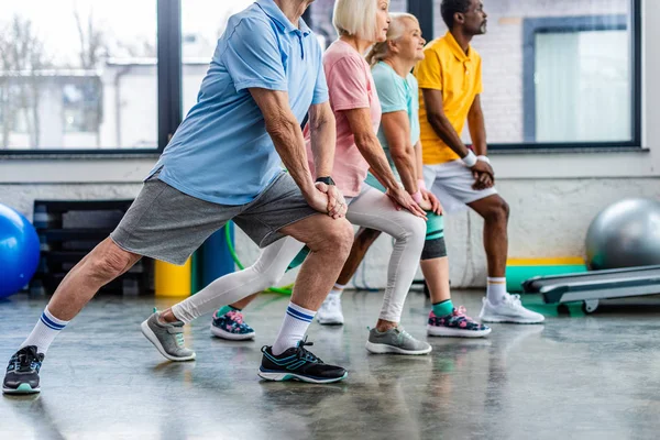 Partial View Senior Multiethnic Sportspeople Synchronous Stretching Gym — Stock Photo, Image