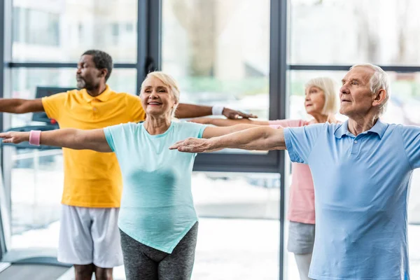 Happy Multiethnic Senior Athletes Synchronous Doing Exercise Sports Hall — Stock Photo, Image