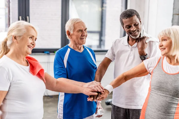 Positiva Multiculutral Senior Idrottare Att Sätta Händerna Ihop Sporthallen — Stockfoto