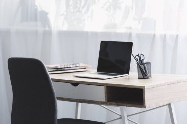 İşyerinde ahşap masa üstünde siyah perde ile dizüstü bilgisayar