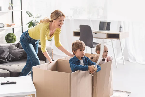 Happy Mother Playing Children Sitting Cardboard Boxes — Stock Photo, Image