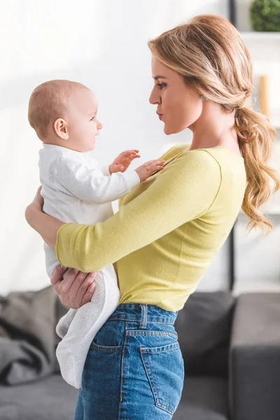 Side View Beautiful Mother Holding Adorable Infant Child Home — Stock Photo, Image