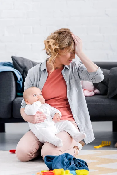 Exhausted Mother Holding Infant Child Sitting Hand Forehead Floor — Stock Photo, Image