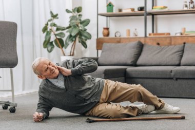 old men falled down on floor and touching neck clipart