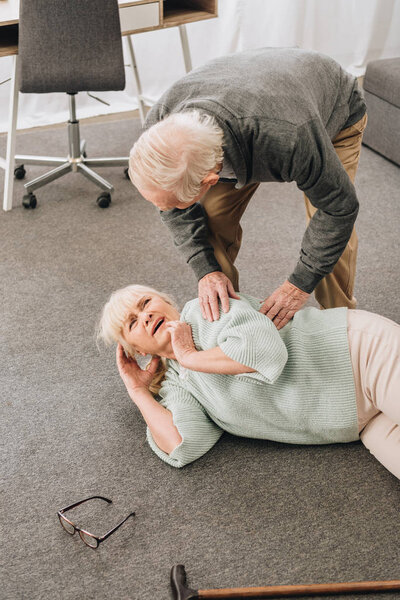 old men looking at wife who falled down on floor 