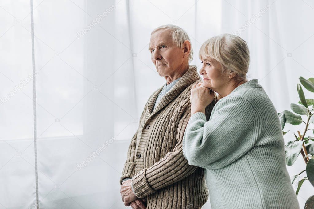 senior couple standing together at home 